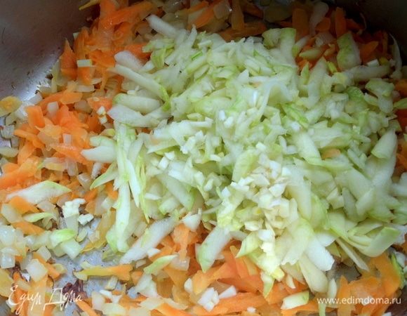 Высыпать к обжаренным овощам кабачок и чеснок.