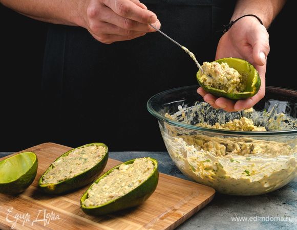 Наполните половинки авокадо салатом и украсьте зеленью.<br />
 