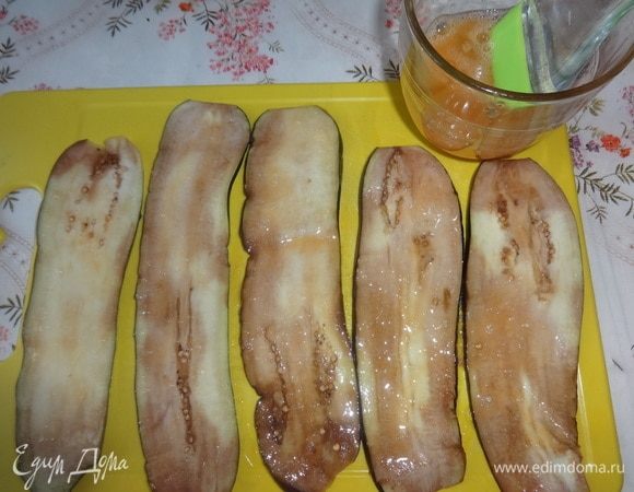 Баклажаны остудить. Яйцо взболтать. Смазать пластины баклажанов яйцом с одной стороны.