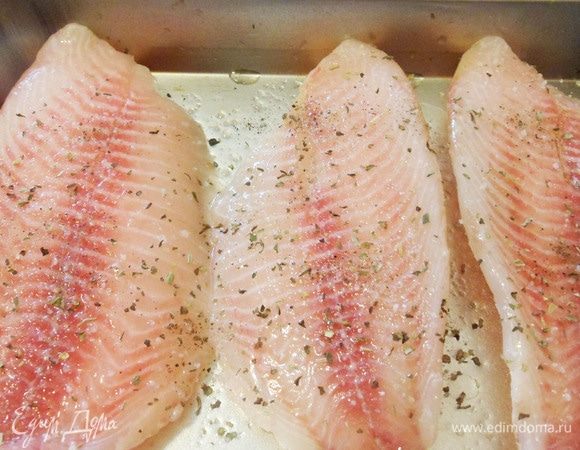 Филе тилапии обмазать растительным маслом и положить в форму для запекания. Рыбу посолить, сверху посыпать любой приправой для рыбы.