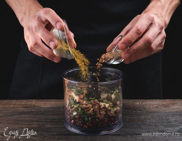 Измельчите в блендере фасоль, орехи, зелень и чеснок, добавьте специи и перемешайте.