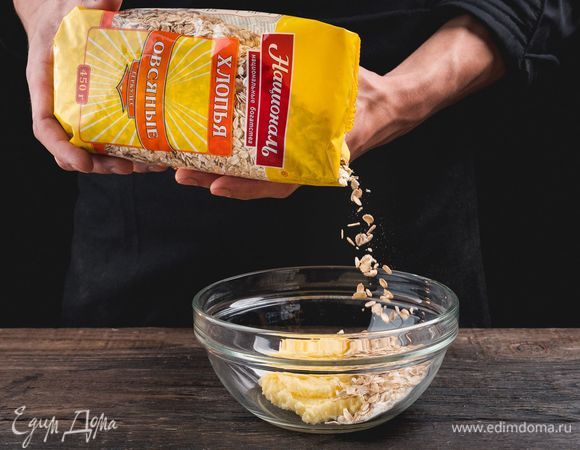 Добавьте овсяные хлопья ТМ «Националь», муку и щепотку соли. Вымесите однородное рыхлое тесто.<br />
 