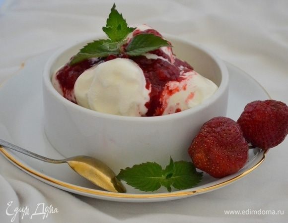 Часа через 3 мороженое готово. Раскладываем его порционно и поливаем ягодным топпингом.
