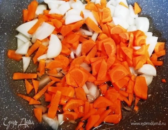 В хорошо разогретое растительное или оливковое масло выкладываем лук и морковь. Обжариваем, помешивая около 10 минут.