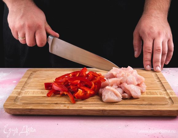 Пока выпекается основа, приготовьте начинку. Для этого куриное филе и перец нарежьте небольшими кусочками.