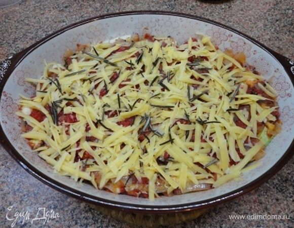 Овощи залить соусом, посыпать тертым сыром и запекать в духовке 20 минут при температуре 200°C.