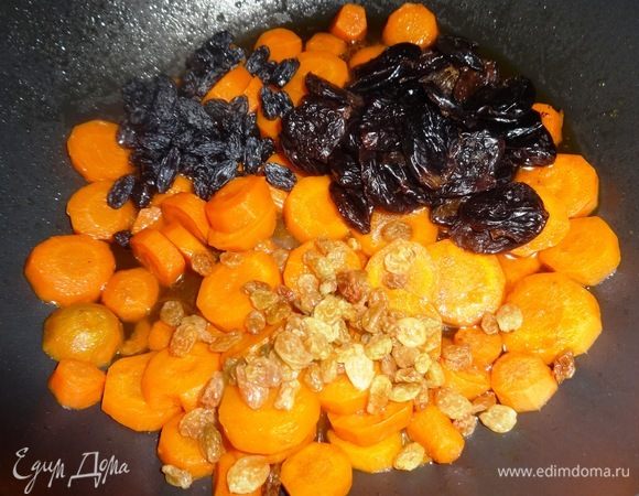 Добавить к моркови чернослив, светлый изюм, черный изюм ТМ «Семушка», перемешать. Продолжать тушить под крышкой в течение 10–12 мин. Затем крышку открыть и продолжать тушить без крышки до почти полного выпаривания жидкости и мягкости продуктов.