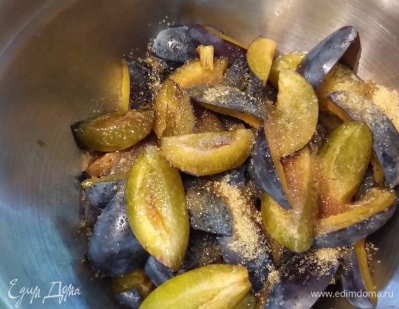 Сливы помыть, обсушить, удалить косточки и нарезать на четвертинки. Сложить в миску. Добавить ликер амаретто и коричневый сахар, отставить в сторону.