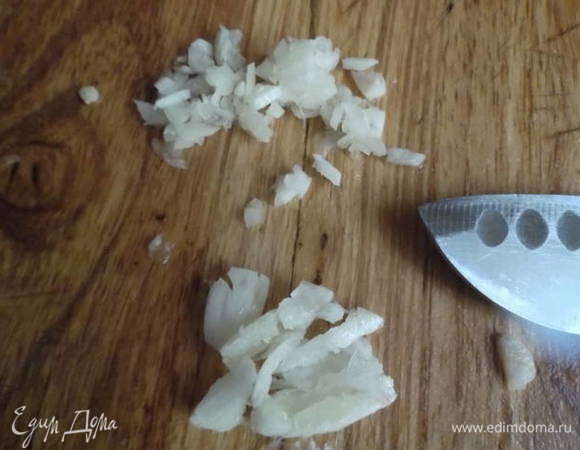 Чеснок раздавить плоской стороной ножа и мелко порубить.