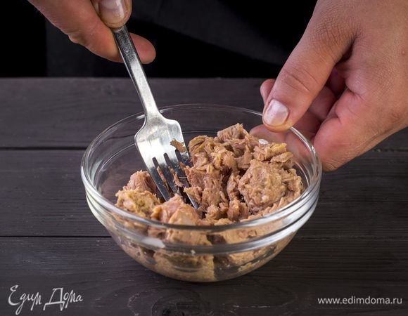 С тунца слейте жидкость и разомните рыбное филе вилкой.