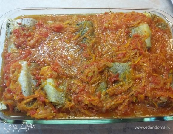 В жаропрочную форму вылить половину соуса. Сверху выложить рыбу и залить оставшимися овощами. Запекать 30 минут при температуре 200°C.