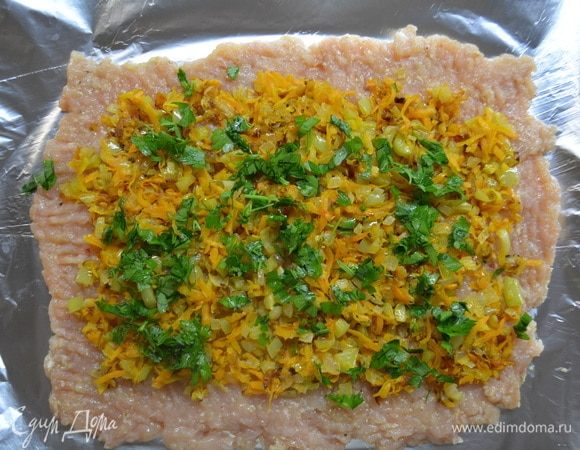 На фарш выложить обжаренные овощи и зелень, разровнять.