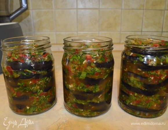В чистые банки все разложить слоями. Сначала соус, потом баклажаны, и так по очереди. Банки лучше брать 0,5 л, небольшие: так удобнее будет раскладывать смесь, снимать и стерилизовать.