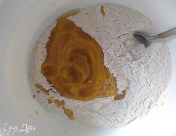 Влить тыквенное пюре к муке и замесить тесто. Месить руками не менее 5 минут. Удобно это делать на силиконовом коврике.