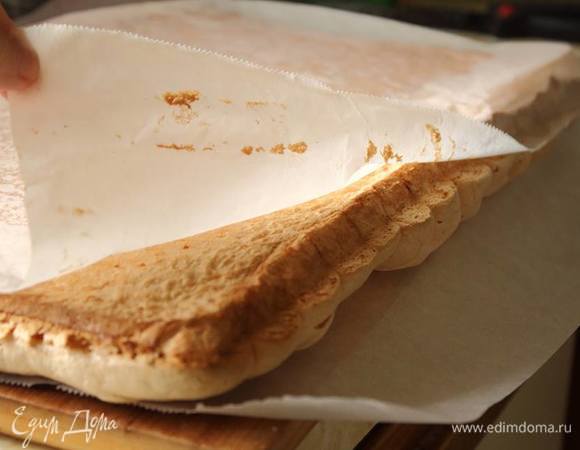 Готовую меренгу вынуть из духовки, тут же перевернуть на другой пергамент и дать немного остыть. Она должна быть не горячей, иначе крем потечет, но и не холодной, чтобы хорошо свернулась в рулет.