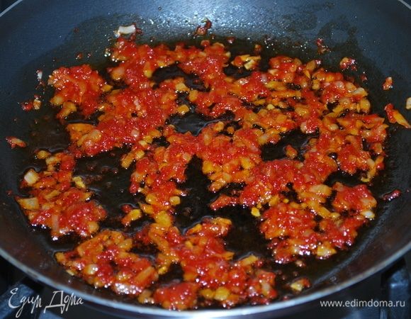 К томатной пасте с луком добавим сахар, в течение минуты обжарим все вместе. Пока лук остывает, приготовим тесто.