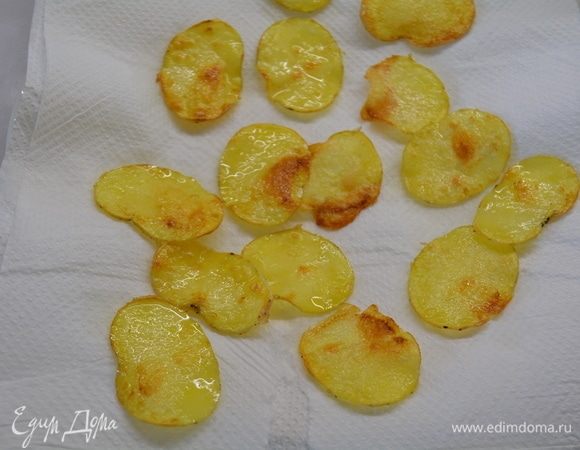 Выложить чипсы из картофеля на салфетку, чтобы впиталось лишнее масло. Посолить.