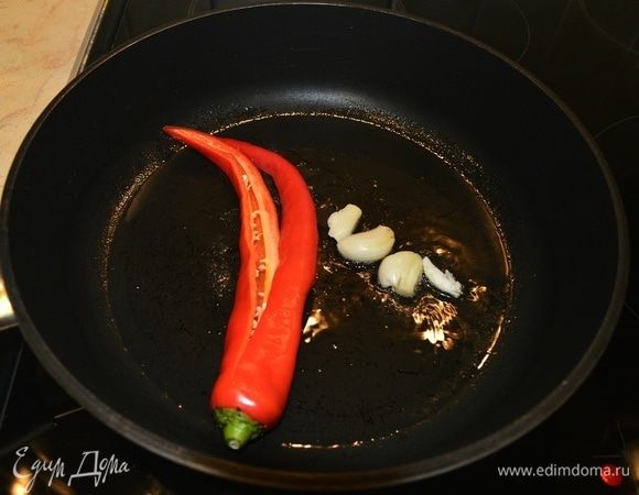 Для салата необходимо несколько секунд обжарить раздавленный чеснок с разрезанным не до конца острым перцем.
