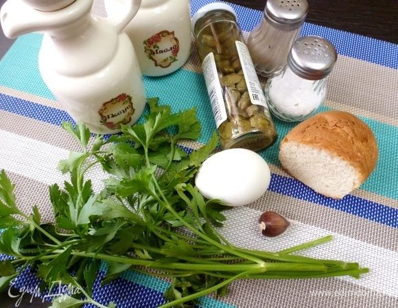 Пока на огне томится лампредотто, приготовить зеленый соус сальса-верде. Куриное яйцо сварить вкрутую и охладить. Чеснок почистить, петрушку помыть. Сбрызнуть пару небольших кусочков черствого батона винным уксусом.