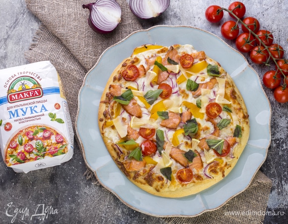 Запекайте пиццу в духовке при 200°C в течение 20 минут. При подаче посыпьте слайсами пармезана, базиликом и украсьте дольками лимона. Приятного аппетита!