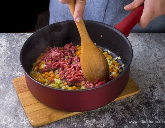 Обжарьте на оливковом масле мясной фарш с измельченными луком, морковью и сельдереем.