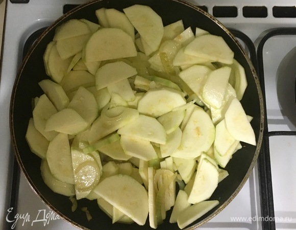 Добавьте кабачок к луку и чесноку, тушите все вместе 10 минут.