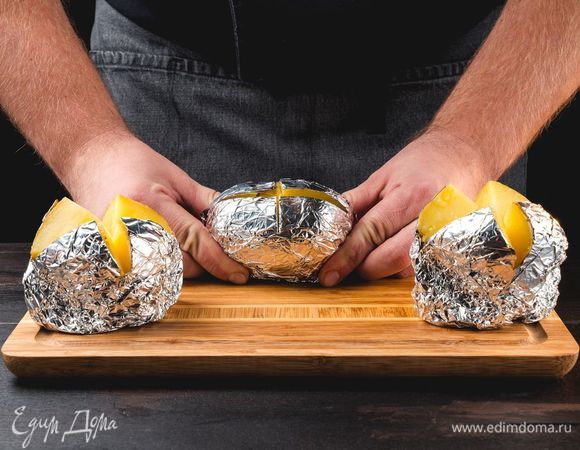 Достаньте готовый картофель из духовки, надрежьте сверху и раскройте в виде цветка.<br />
 