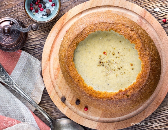 Постепенно ввести плавленый сыр в суп, варить еще пару минут, затем взбить блендером до однородности. Налить суп в горячий подрумяненный хлеб и приправить смесью перцев.