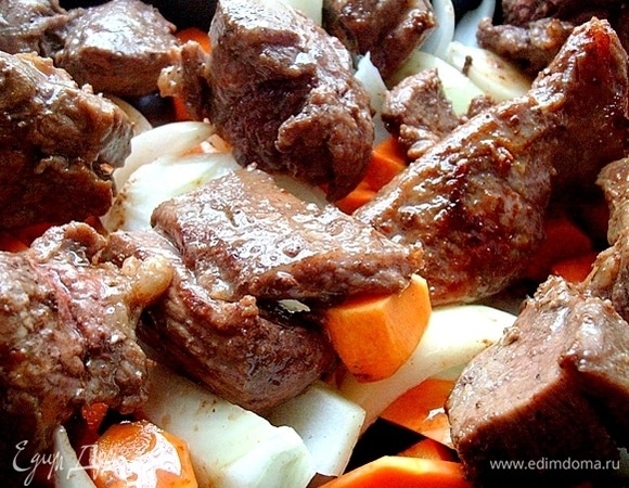 Смазываем маслом форму, в которой будем запекать мясо и овощи. Вниз кладем морковь, тыкву и лук, на них размещаем обжаренную телятину. Поливаем все соком, выделившимся при обжаривании. Отправляем мясо в горячую духовку на 30 минут. Выпекаем мясо при 170°C.