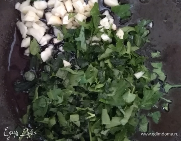 Чеснок очистить и мелко порубить. Петрушку и зеленый лук нарезать. В сковороду, где жарились грибы, добавить еще ложку растительного масла и всыпать чеснок, петрушку и лук. Готовить 1 минуту на среднем огне, помешивая.