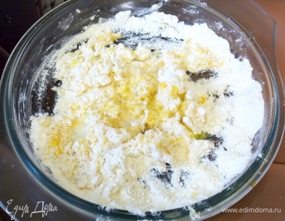 Начинаем перемешивать с середины, захватывая постепенно края. Добавить масло и воду и продолжить замешивать тесто.