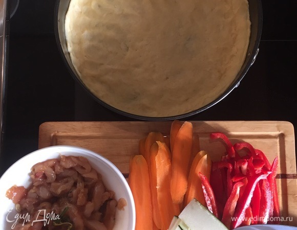 Готовим тесто: 1 стакан муки + 1 стакан теплой воды + 3 ст. л. оливкового масла + 1 щепотка сахара и 1 щепотка соли. Вымешиваем и распределяем по форме для выпечки. Тонкими слайсами продольно нарезаем овощи. И так же тонко продольно режем куриную грудку. Куриную грудку маринуем 15 минут в соевом соусе, смешанном с карри и медом.