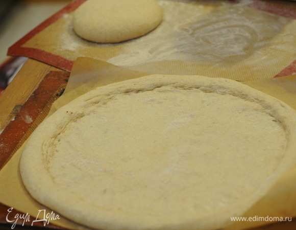 Теперь самое интересное — формируем пиццу. Растягиваем и пальцами сдвигаем пузыри и тесто к бортам, оставляя края размером 2 см.