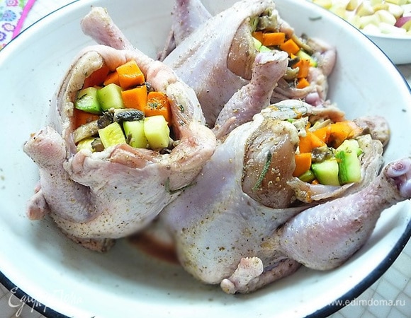 Через 20 минут начиняем тушки цыплят овощами. В районе гузки делаем надрезы и складываем ножки крест-накрест.
