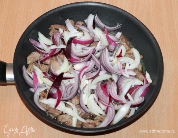 Уменьшаем огонь. Кладем очищенные и порезанные: чеснок и репчатый лук, жарим до прозрачности.