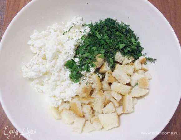 В емкости смешать творог, мелко нарезанную зелень и поджаренные сухари. Посолить и поперчить по вкусу.