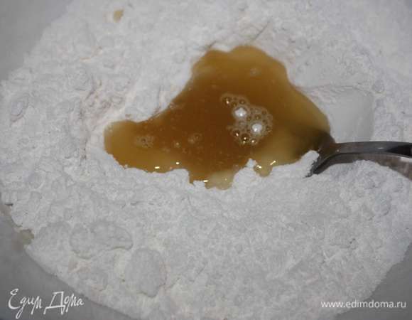 В сахарной пудре делаем лунку и вливаем полученную смесь. Сахарную пудру нужно предварительно обязательно просеять.