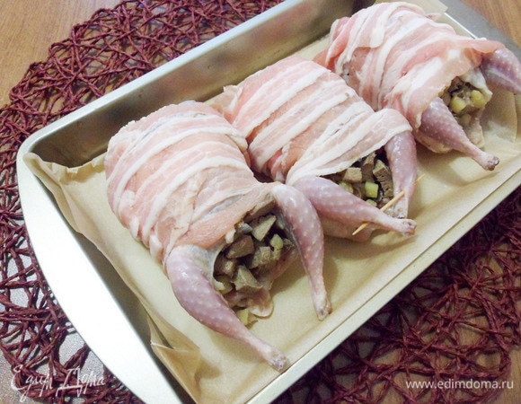 Форму для выпечки застелить пергаментом, уложить перепелок спинкой вниз и поставить в разогретую до 180°C духовку на полчаса.