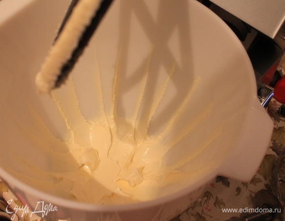 Растворить желатин на водяной бане, соединить с горячим кремом. Выключить нагрев комбайна и, не останавливая перемешивание, остудить до комнатной температуры. Взбить масло насадкой для мягких смесей до пышности.