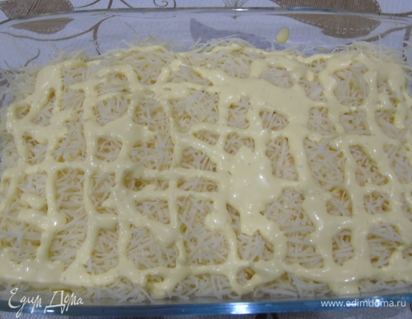 Затем натрите сыр на средней терке, покройте сеточкой майонеза.