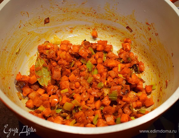 Добавить к овощам томатную пасту, розмарин, тимьян, лавровый лист, черный перец молотый, перец чили молотый и яблочный уксус. Перемешать. Затем добавить муку и снова все перемешать.