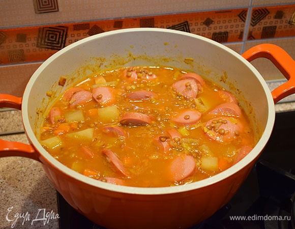 Добавить сардельки, накрыть крышкой и варить еще 5 минут. После добавить еще соль и сахар по вкусу. Подавать, посыпав петрушкой.