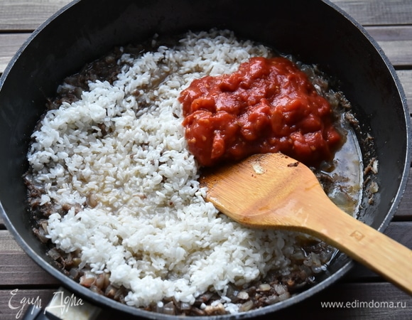 Рис «Гигант» ТМ «Националь» промыть, выложить в сковороду к мясу. Туда же добавить томаты, соль, немного сахара, смесь прованских трав. Все перемешать.