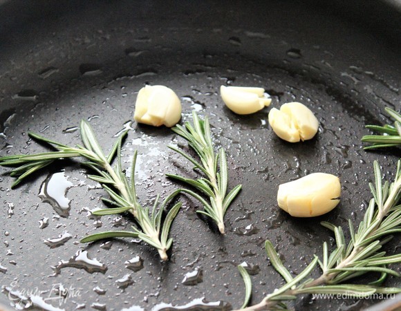 Выложить чеснок и веточки розмарина. Обжарить 2–3 минуты и убрать со сковороды.