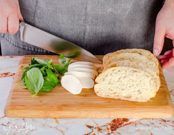 <span>Нарежьте чиабатту кусочками толщиной 1,5</span>–<span>2 см. Моцареллу нарежьте, листья базилика порвите крупно руками.</span>