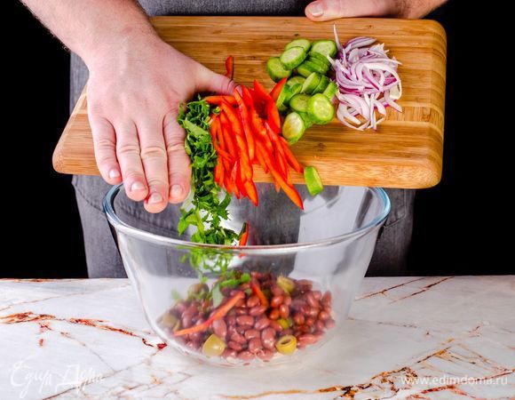 Далее положите в салатник нарезанные овощи с зеленью. Перемешайте.
