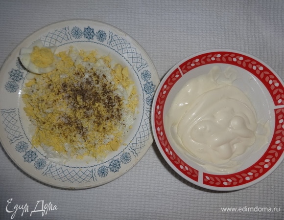 Яйца отварить вкрутую, охладить в холодной воде. Яйца почистить, отрезать небольшой кусочек яйца для украшения. Остальные яйца натереть на мелкой терке. Яйца немного посолить, поперчить, соединить с 3 ст. л. майонеза, перемешать.