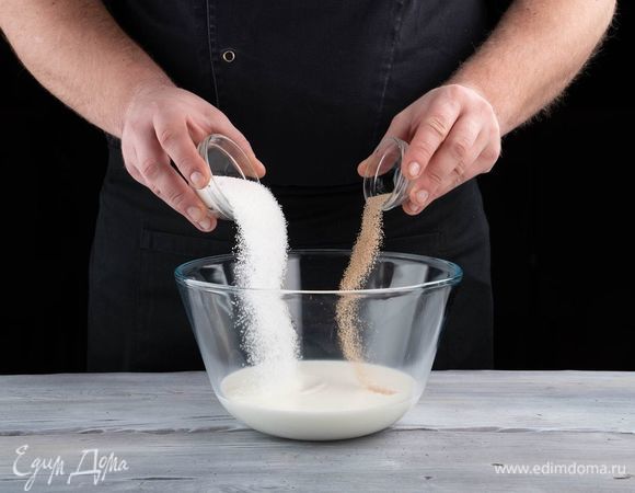 В теплом молоке растворите сахар, добавьте дрожжи, все перемешайте. Поставьте в теплое место на 15 минут, чтобы опара поднялась.