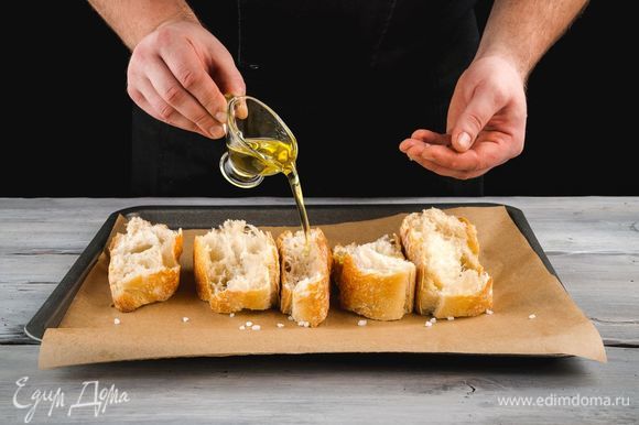 Пока варится суп, приготовьте сухарики. Нарежьте белый хлеб крупными ломтиками, выложите на противень. Сбрызните хлеб оливковым маслом и посолите слегка. Запекайте до золотистого цвета при 180°С.