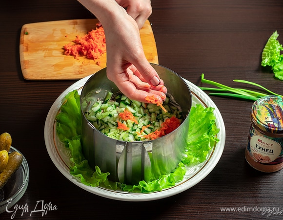 Вареную морковь натрите на терке и выложите в салат. Снова смажьте майонезом.